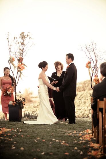 A couple exchanging vows in an outdoor wedding ceremony.