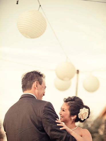 Couple sharing a joyful dance under hanging lanterns.