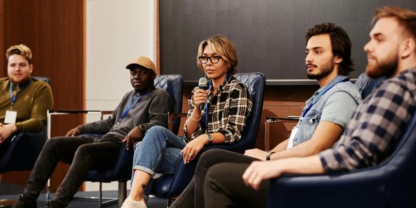 Panel discussion with five people seated on stage.