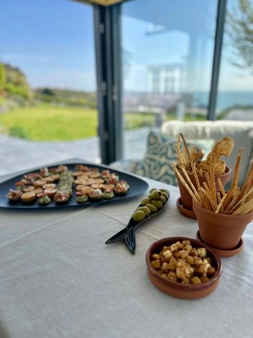 Appetizers arranged on a table with a garden view.