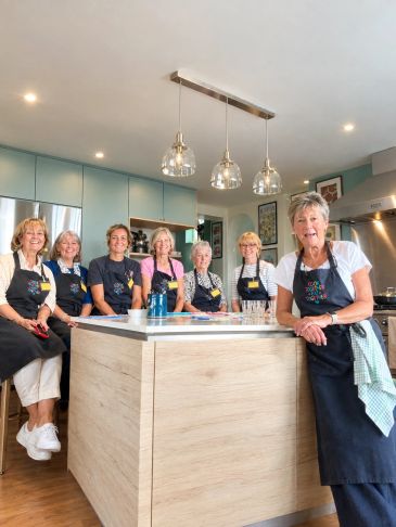 Group of women chefs in a kitchen.