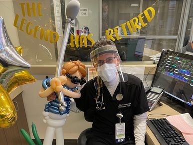 Robert Realmuto celebrates his retirement with balloons and coworkers.