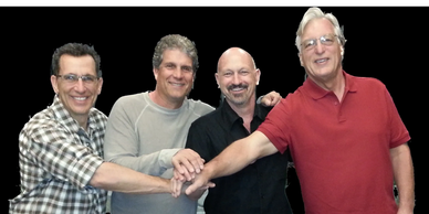 Robert Realmuto and friends linking hands and smiling together.