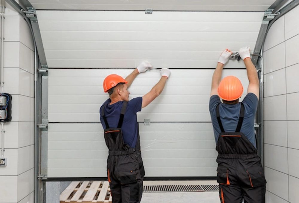 Workers installing a garage door