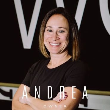 Confident woman named Andrea, smiling with arms crossed.