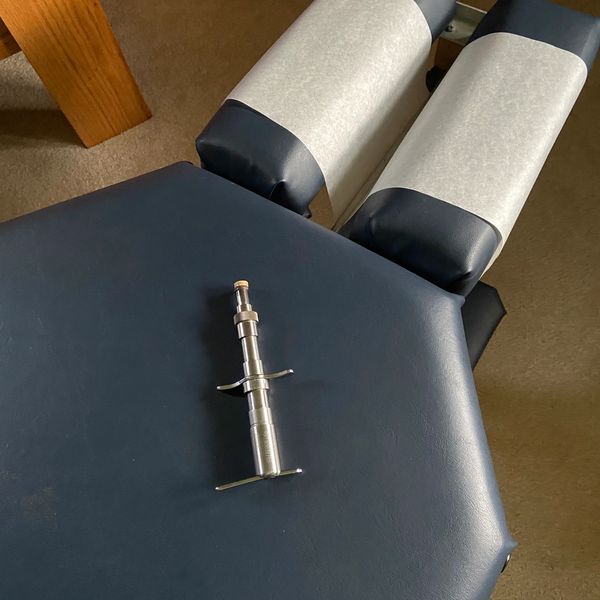 Chiropractic adjusting table and instrument