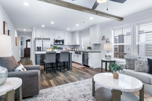 Modern open kitchen and living area with neutral tones.