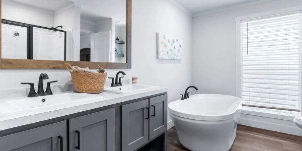 Modern bathroom with double sinks and a freestanding tub.