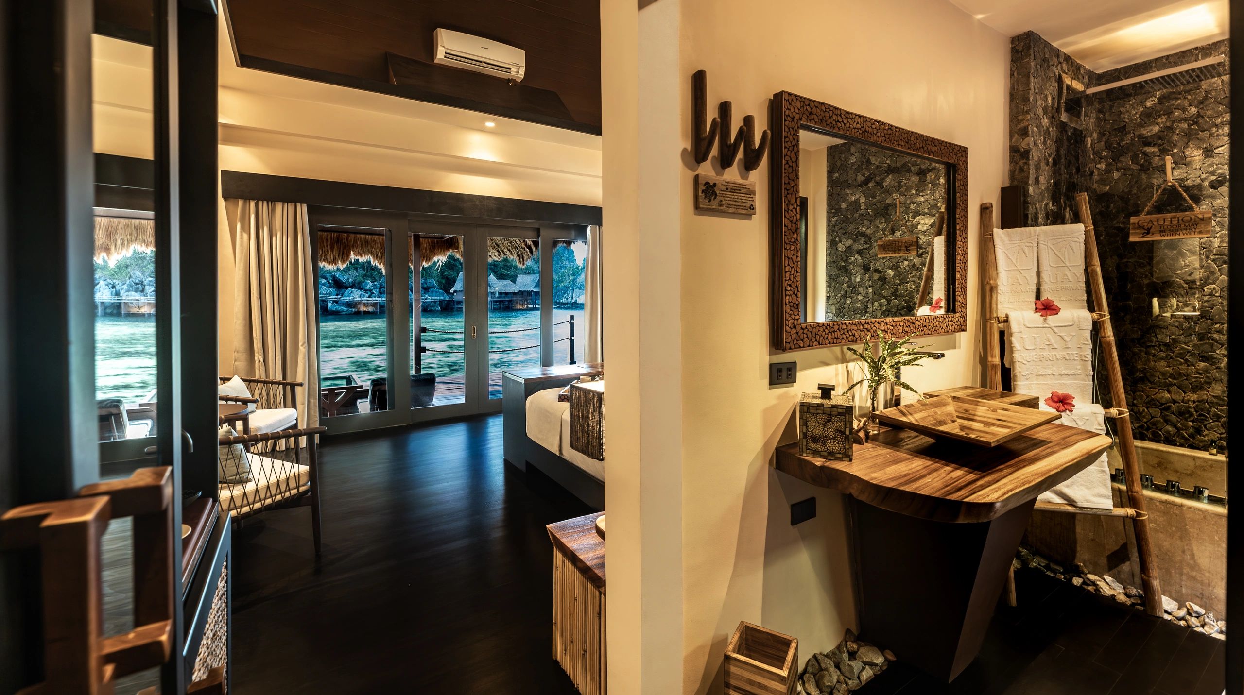 Luxurious overwater bungalow with tropical decor and ocean view.