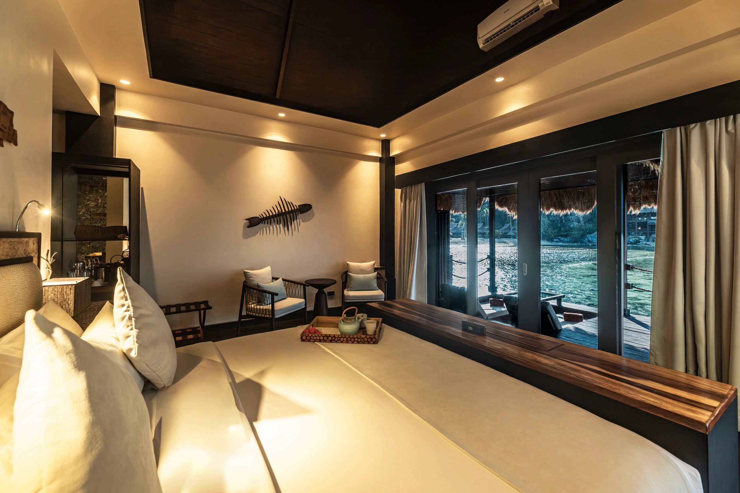 Cozy hotel room with a water view and modern decor.