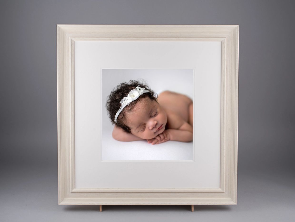 newborn baby photoshoot image in a wooden professional frame. Cuffley Hertfordshire