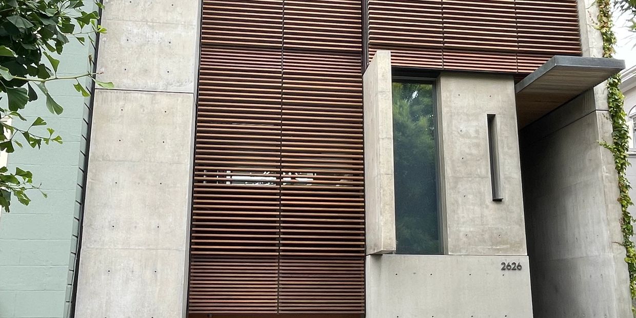 Modern building facade with concrete and wooden slats.