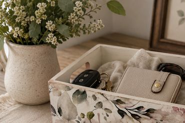 Decorative box holding everyday essentials and sunglasses.