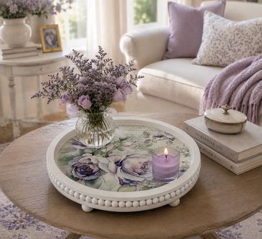 Cozy living room with floral decor and a lit candle.