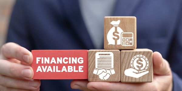 Hands holding blocks symbolizing financing availability and financial services.