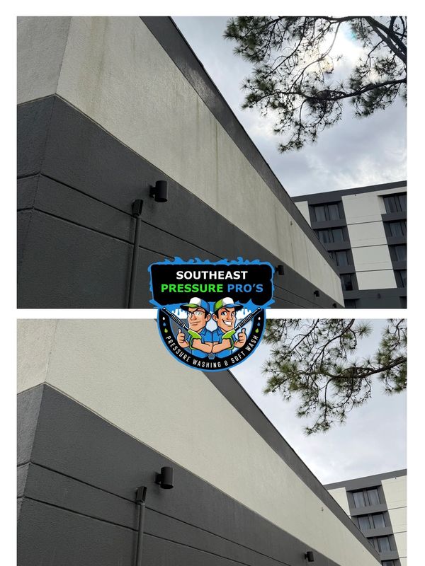 Before and after pressure washing of a building's exterior wall showing a clean transformation.