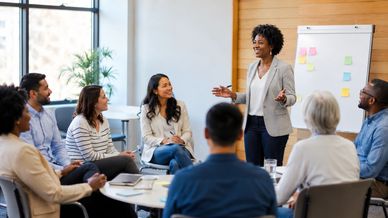A woman leads a group meeting in a modern office.