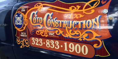 Vehicle door with Coto Construction signage and phone number.