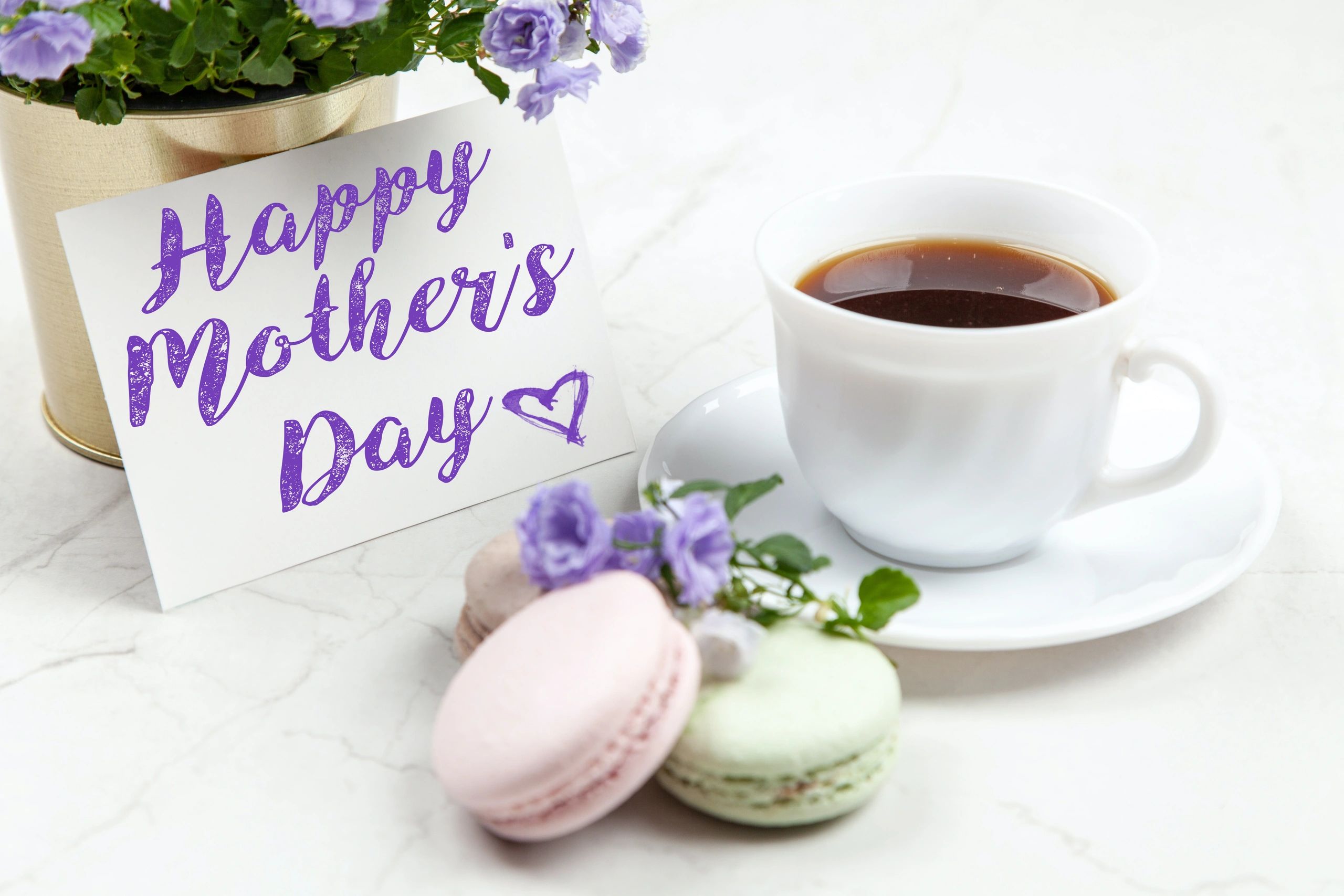 Happy Mother's Day card with coffee, flowers, and macarons.