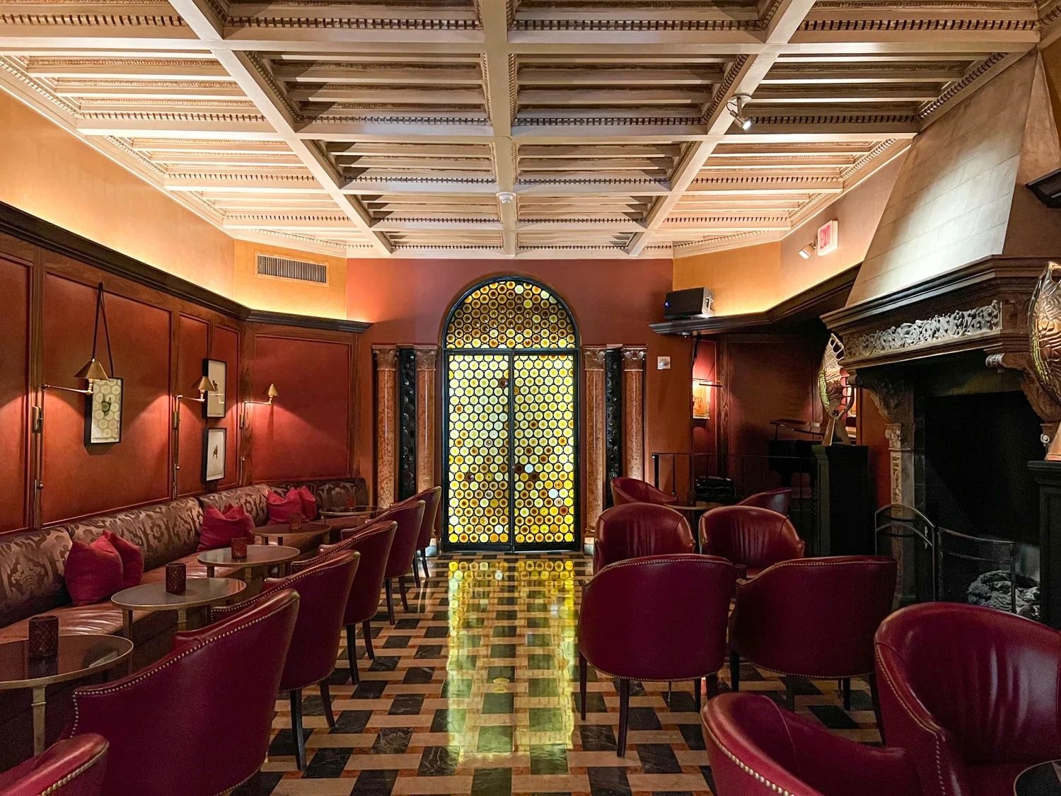 Elegant lounge with red leather chairs and warm lighting.