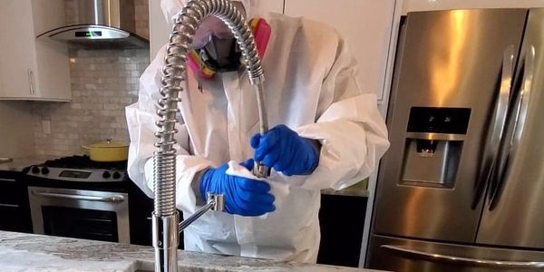 Biohazard Decontamination Technician cleaning and disinfecting possible coronavirus contamination.