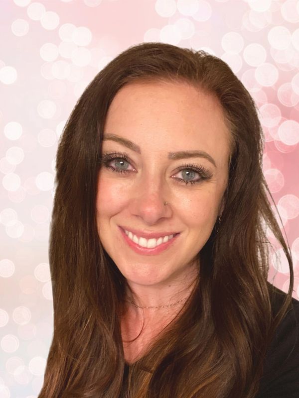 Photo of smiling woman with blue eyes and brown hair