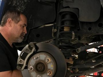 Mark Perkins performing a brake repair on a truck.