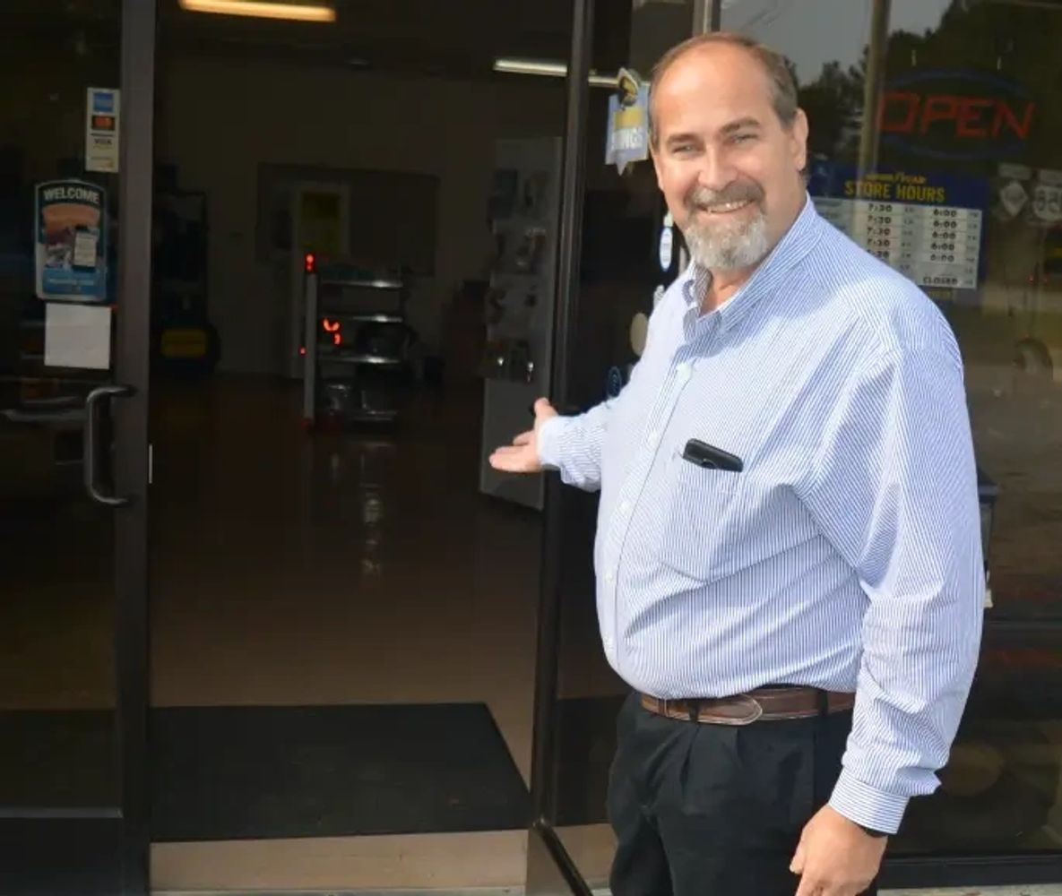 Mark Perkins welcoming customer through the door to the office for Lake Gaston Auto & RV
