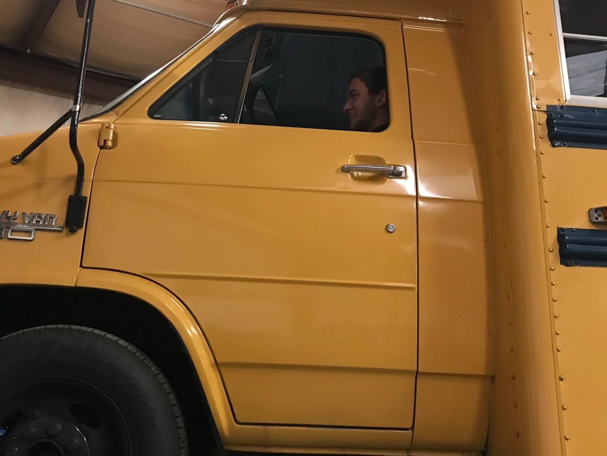 Alex driving a 1999 Ford F-150 XLT on to a lift for services and repairs.