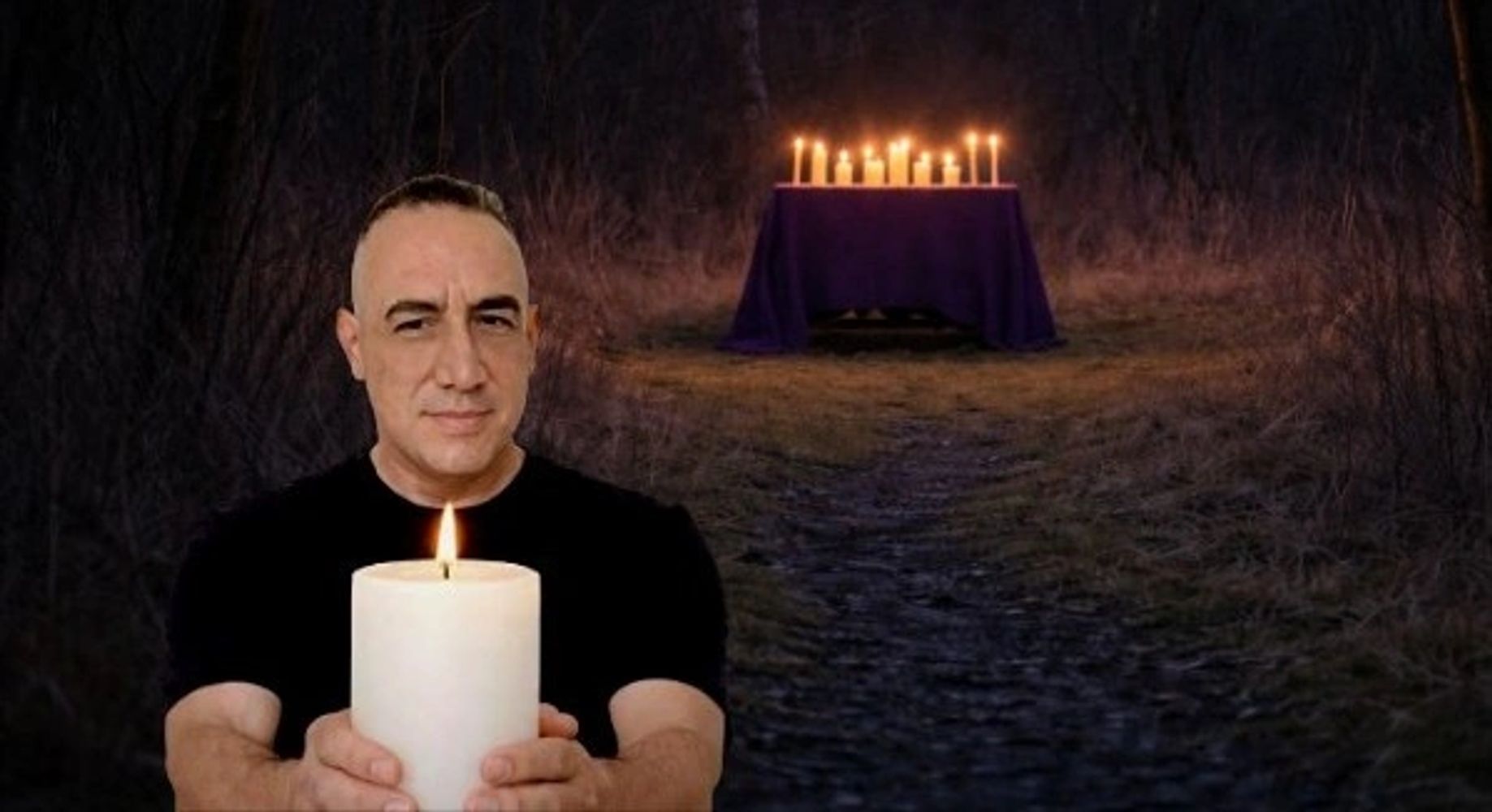 James holding a lit white candle during a spellcasting ritual.