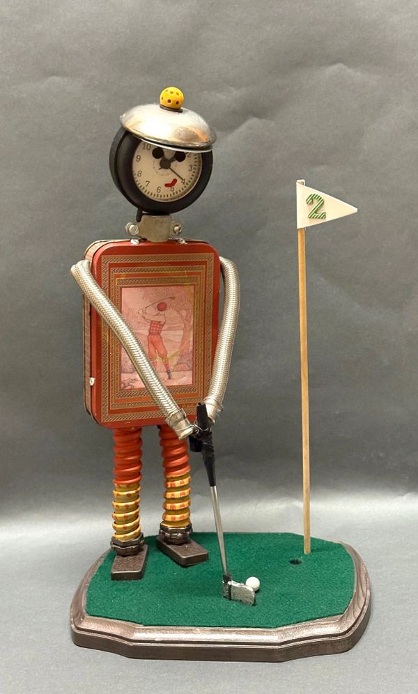 A robot golfer sculpture made from various metal parts and a clock face.
