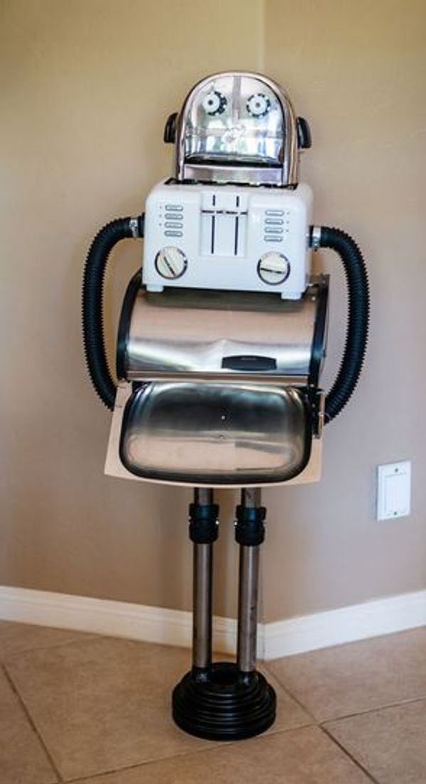 A robot sculpture made from household appliances and metal parts.