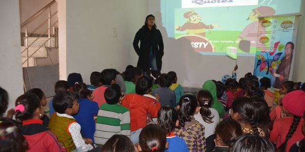 Interactive educational session conducted for the children of Harijan Basti