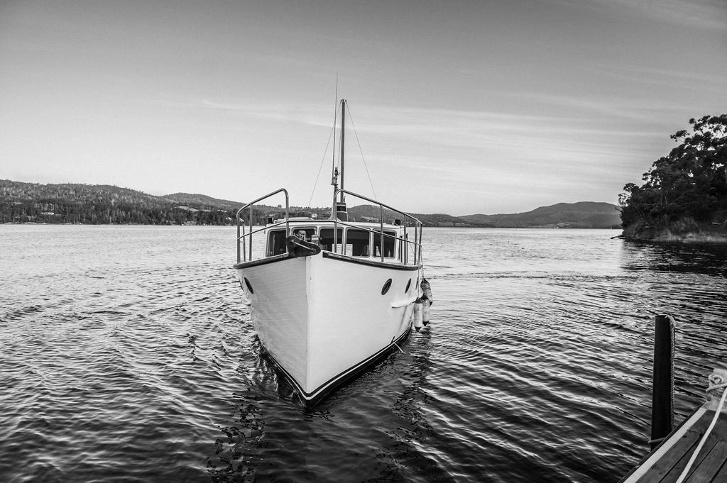 Elopement Cruise - Huon River Cruises - In black and white the vessel LaDrone approaches the dock