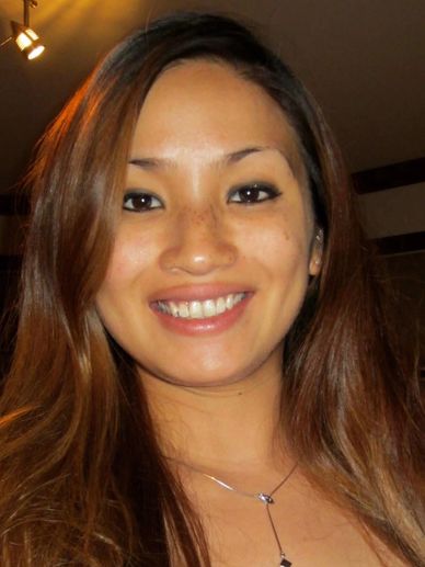 Smiling woman with long brown hair.