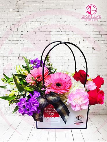 Beautiful handbag with Mixed floral  of roses, guerberas, carnations, cremona astromelias