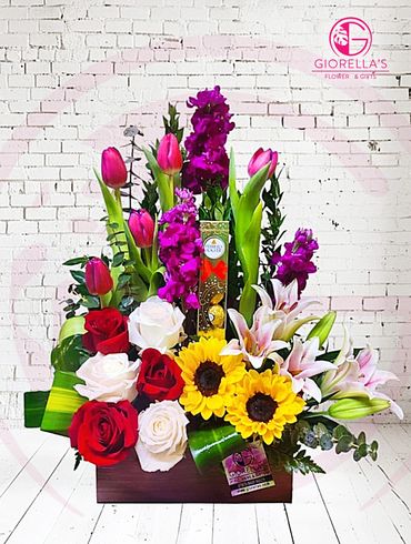 Flower mix arrangement with roses, sun flower, hydrangeas, orchids and green mix 