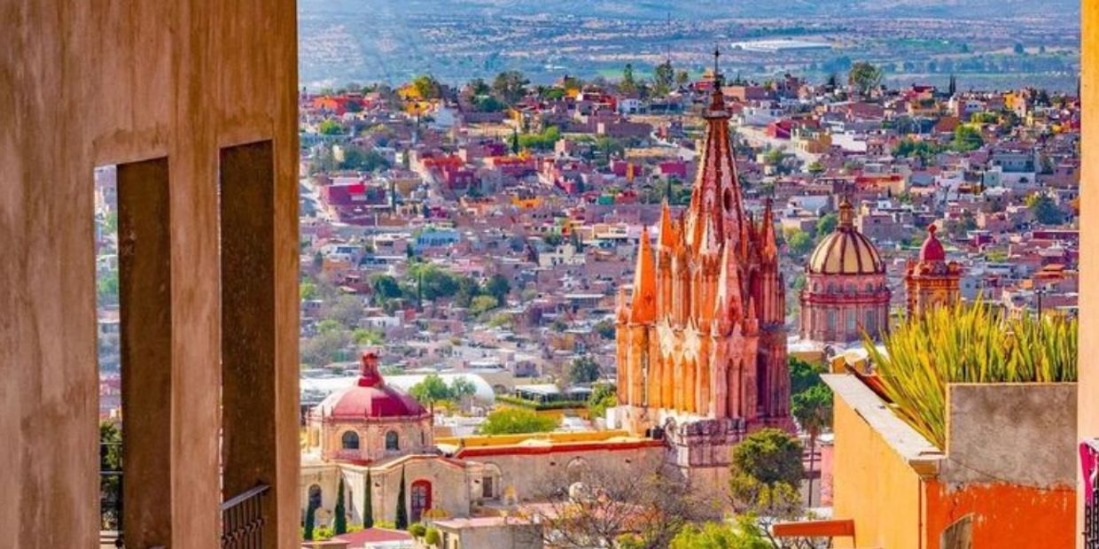 Cityscape with colorful buildings and ornate church.