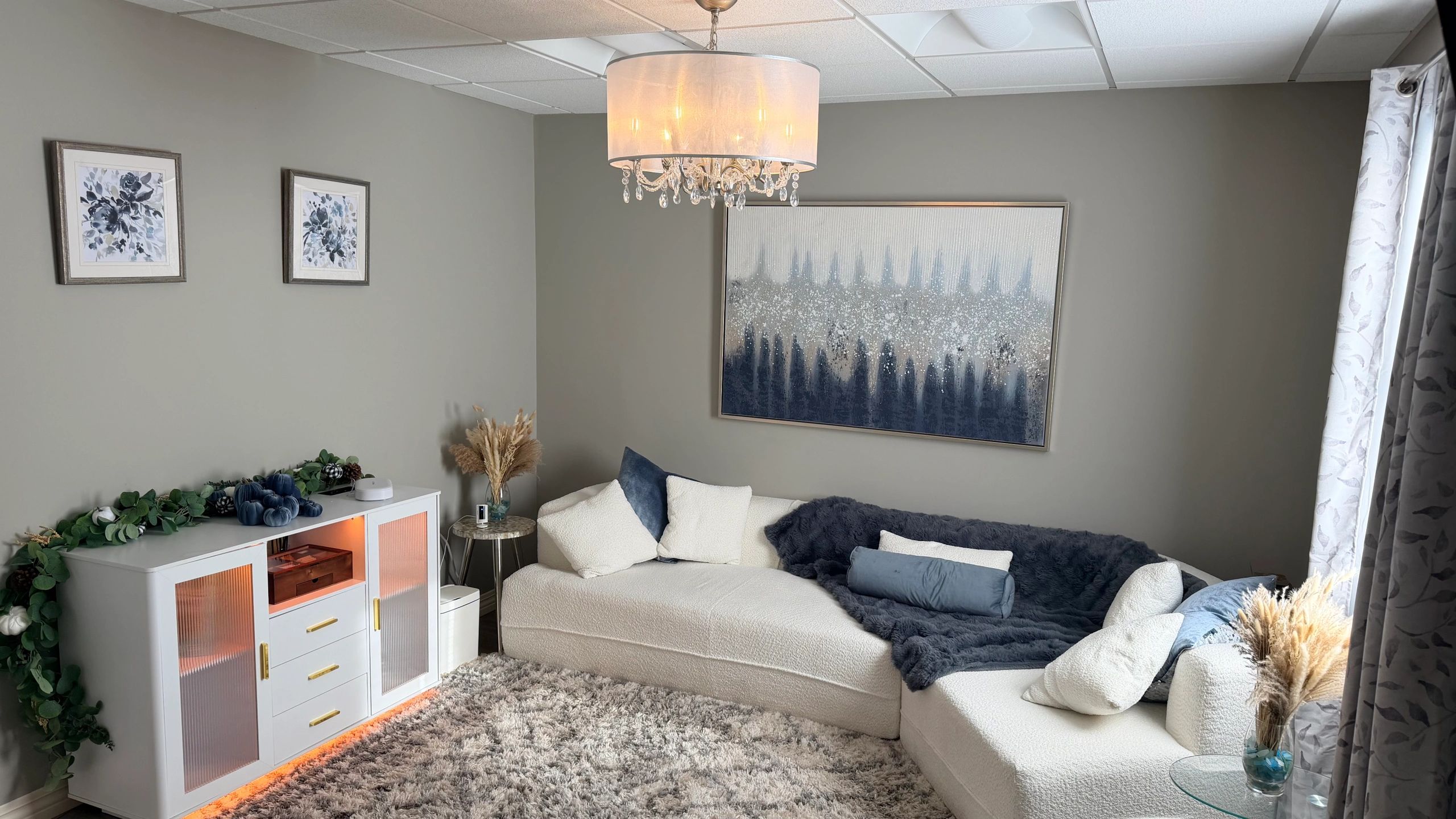Cozy living room with neutral tones and blue accents.