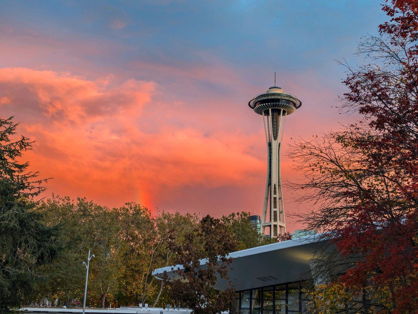 Space Needle at sunset with vibrant orange and blue sky.