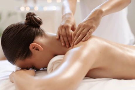 A woman receiving a relaxing neck and shoulder massage.