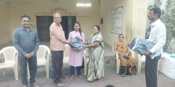 Group of people distributing clothes.