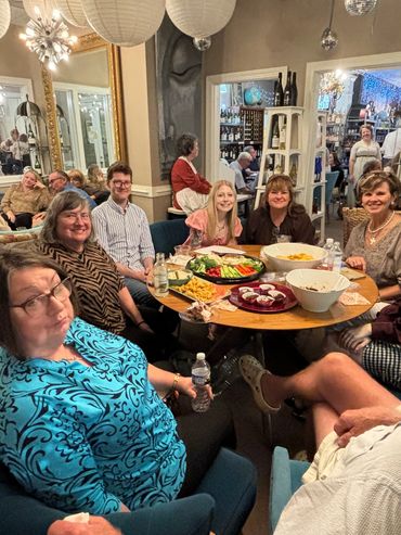 Group of people enjoying a cozy indoor gathering with snacks.