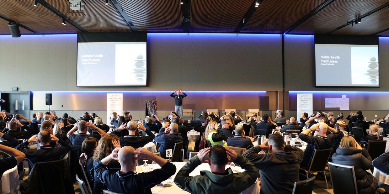 Audience participating in a mental health mindfulness seminar.