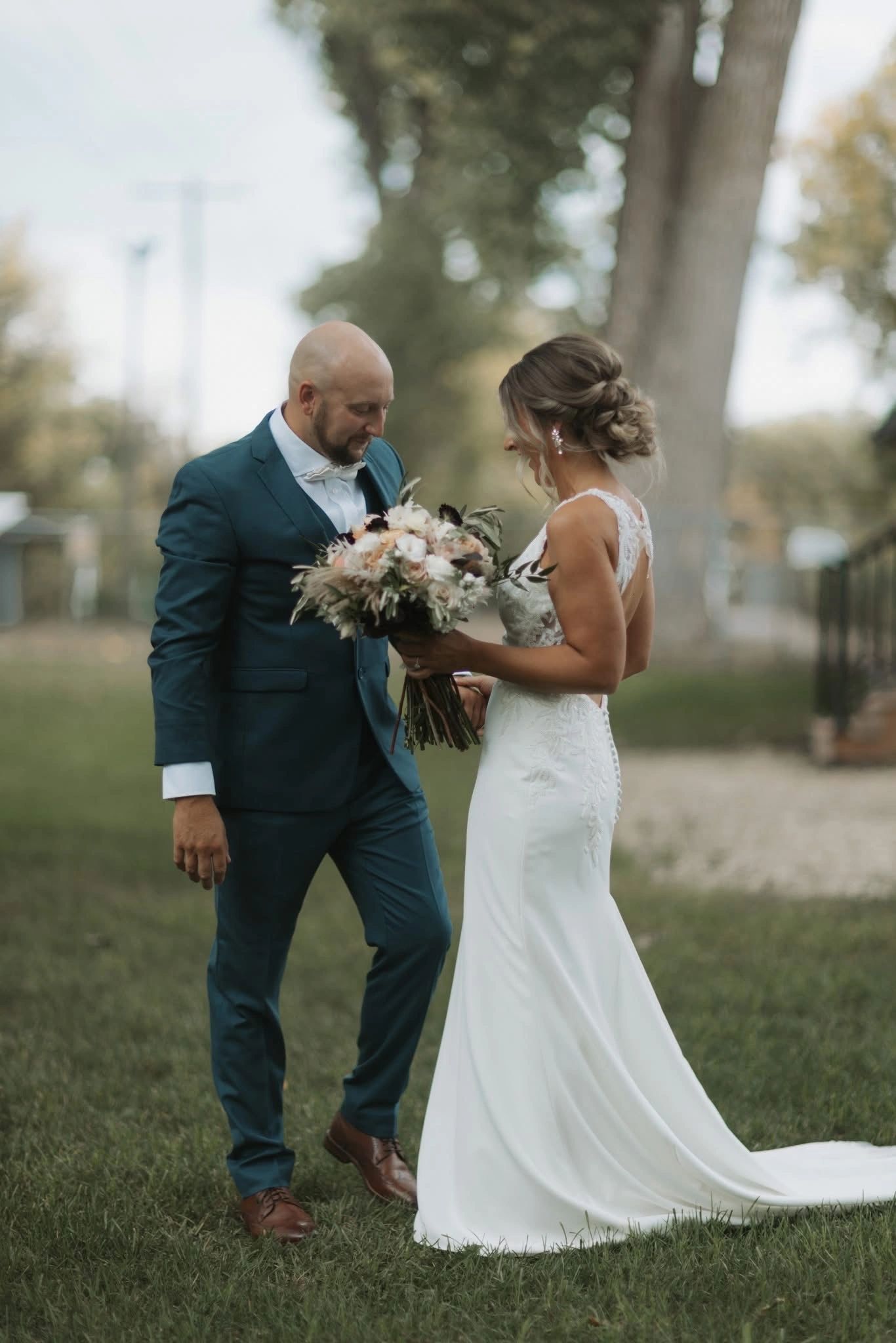 Bride and groom sharing a moment outdoors on their wedding day.