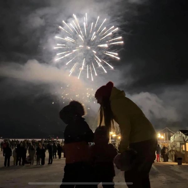 People watching fireworks at night.