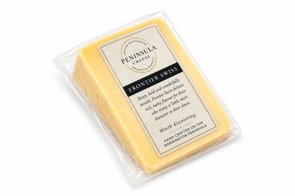 Block of Peninsula Cheese Frontier Swiss in clear packaging.
