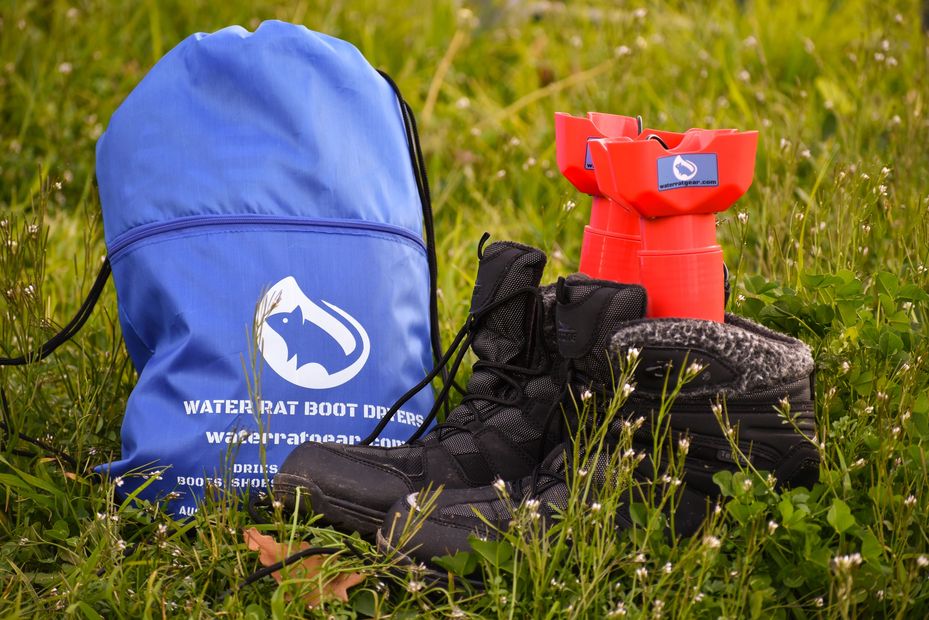 The portable USB powered Water Rat Boot Dryers and string-pull bag pictured with boots outdoors
