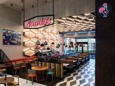 Chic Nando's interior lighting design with honeycomb lights and bold design.