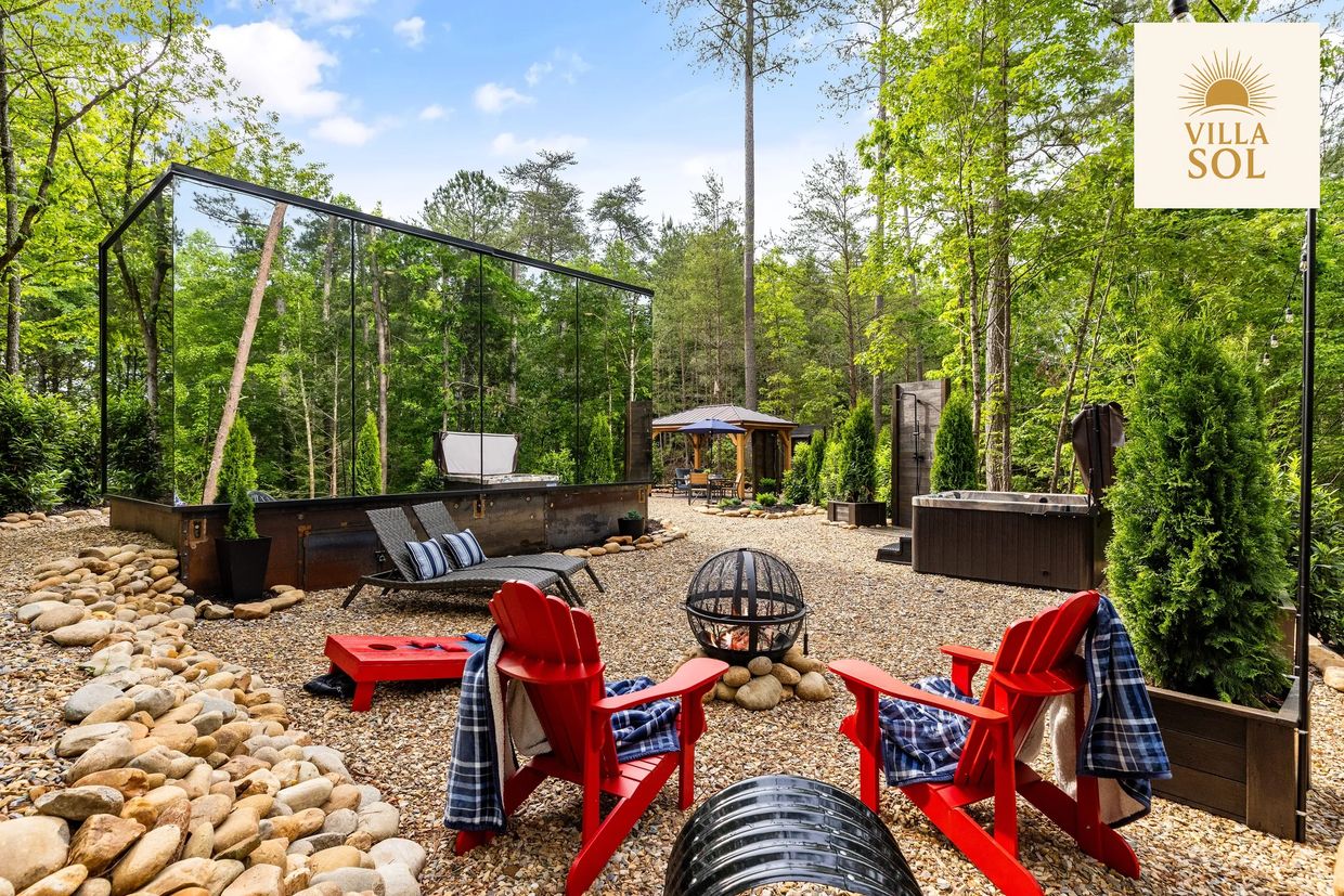 Outdoor space at Villa Sol mirror house with firepit, outdoor games, hottub, and outdoor shower.